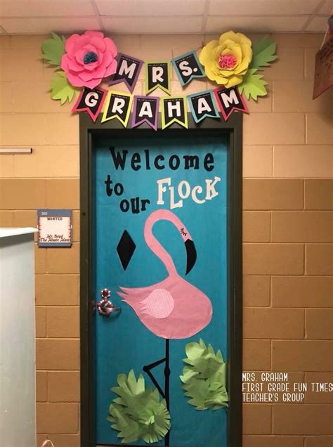 a door decorated with flowers and a pink flamingo