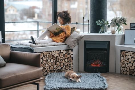 Premium Photo | Leisure. a girl reading a book on the window