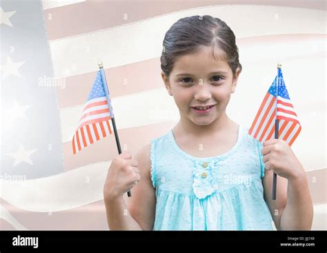 ILittle girl holding Americans flags against american flag Stock Photo - Alamy