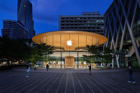 Apple plants timber "Tree Canopy" at center of circular glass store