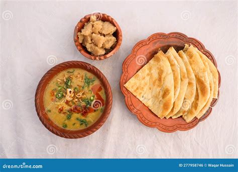 Desi Breakfast, Haleem, Halim, Dhaleem, Halwa and Paratha Served in Dish Isolated on Background ...