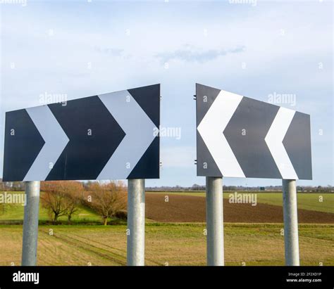 Black and white arrow road sign Stock Photo - Alamy