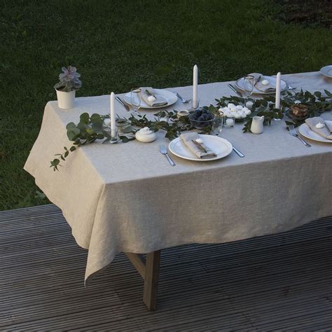 the table is set with white plates and silverware