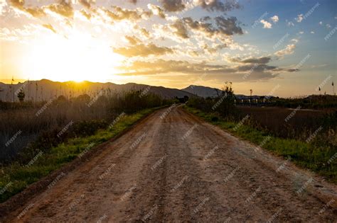 Premium Photo | Dirt Road pathway at sunset