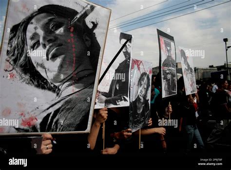 Protesters carry posters with pictures of victims of the Tlatelolco massacre during a march to ...