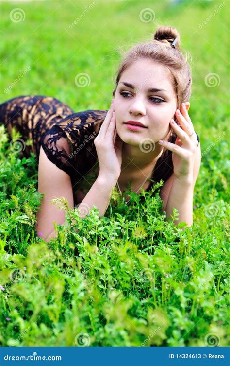 Girl Laying In Bright Green Grass Stock Photos - Image: 14324613