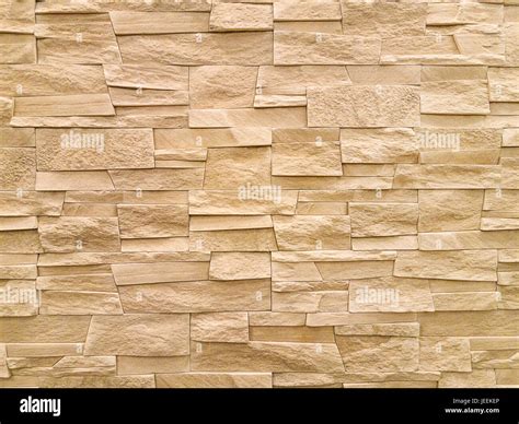 Modern sandstone stone wall background texture Stock Photo - Alamy