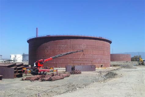 New Installation Crude Oil Storage Tank with Floating Roof and a Crane in the Construction Site ...