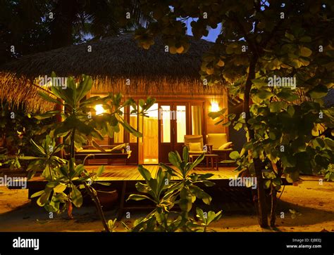 Beach bungalow at sunset - Maldives Stock Photo - Alamy