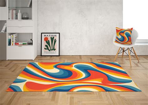 a living room with an area rug that has colorful swirls on it and a chair in the corner