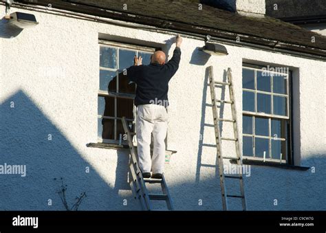 Man painting house Stock Photo - Alamy