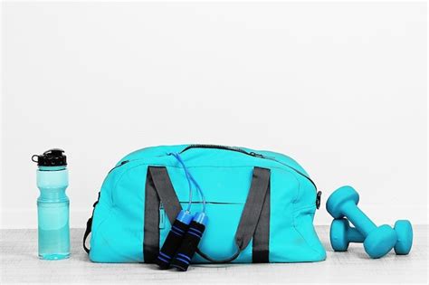 Premium Photo | Sports bag with sports equipment in room