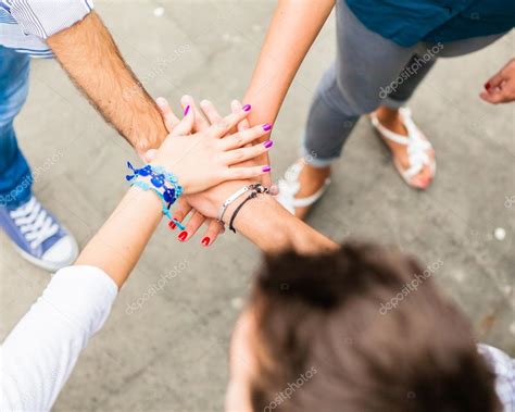 Group of friends holding hands in stack Stock Photo by ©GiorgioMagini 122927994