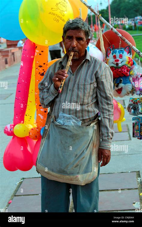 Man selling balloons to city Stock Photo - Alamy