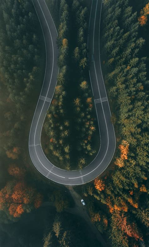 Download 1280x2120 wallpaper curve, road, highway, aerial view, nature ...