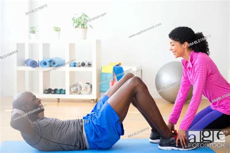 Man doing sit-ups with trainer in gym, Stock Photo, Picture And Royalty Free Image. Pic. BIM ...