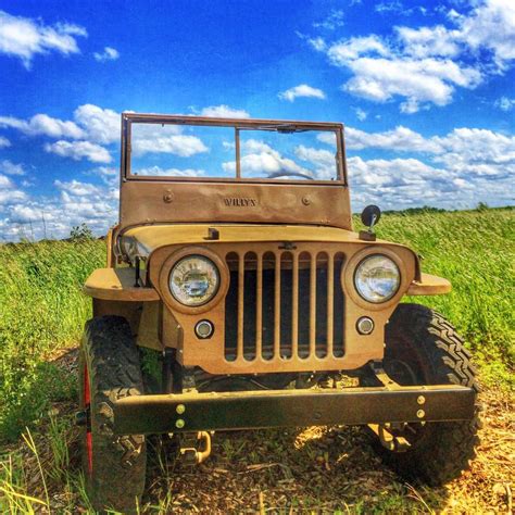 Old Willys Jeep in a field - Jeep Wrangler Parts