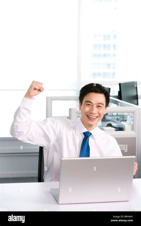 Happy office worker at his desk Stock Photo - Alamy