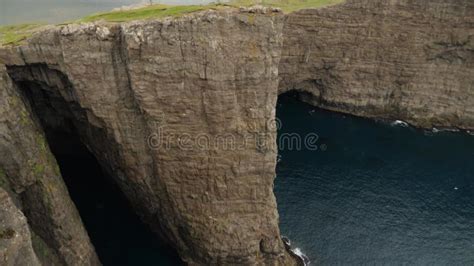 View of Sorvagsvatn Lake Above the Ocean and Legs Man Sitting Edge ...