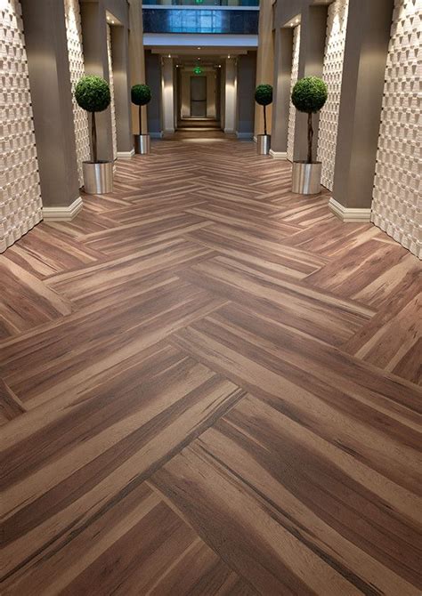 Hotel corridor featuring Affinity255 Smoked Walnut vinyl flooring in herringbone pattern | Vinyl ...