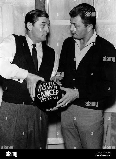 American actor Robert Mitchum and his son, Jim Mitchum, discussing ...