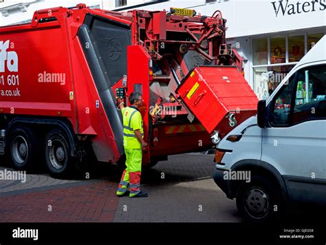 Bin-man emptying bin into lorry, England UK Stock Photo - Alamy