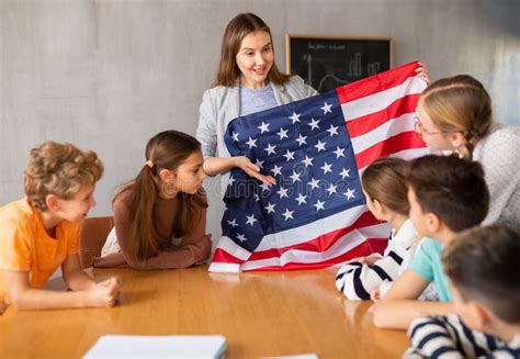 Geography Lesson in School Class - Teacher Talks about United States of America, Holding Flag in ...