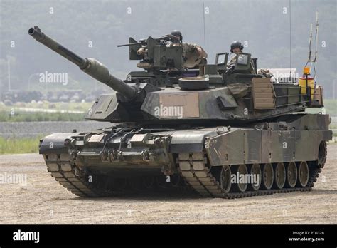 A Abrams tank crew await their iteration during a proficiency qualification table during the 1-9 ...