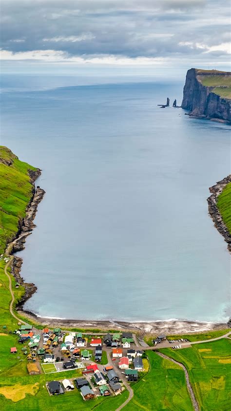 Aerial view of a small town Tjørnuvík on the Atlantic Ocean, Faroe ...