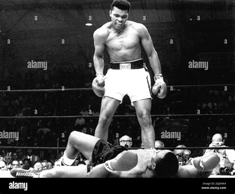 (Muhammad Ali) Cassius Clay in the boxing ring standing over Sonny Liston 1965 Stock Photo - Alamy