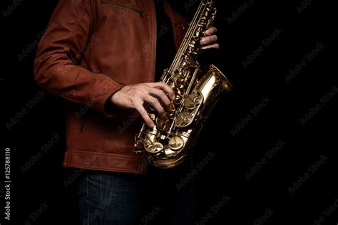 Foto de Jazz saxophone musician in the leather jacket, closeup. do Stock | Adobe Stock