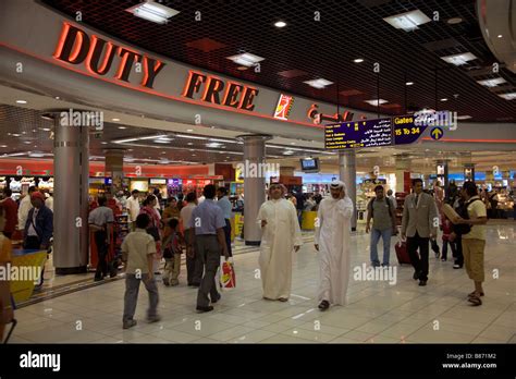 Passengers in a departure lounge outside the duty free shop. Bahrain airport Stock Photo - Alamy