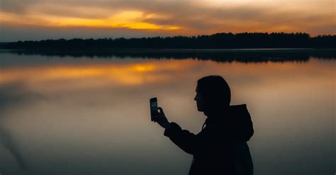 Silhouette of Person Holding Smartphone · Free Stock Photo