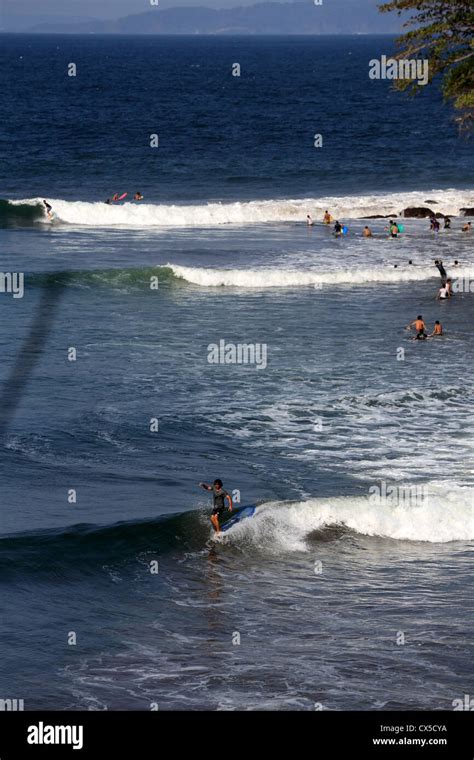 Local longboard surfer surfing a wave at Batu Karas in West Java, Indonesia Stock Photo - Alamy