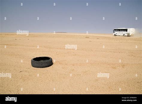 Broken tire and bus in a arid desert Stock Photo - Alamy