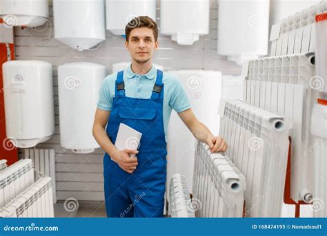 Plumber in Uniform Choosing Water Heating Radiator Stock Image - Image ...