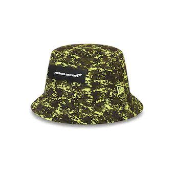 a black and yellow bucket hat with the word, supreme on it's side