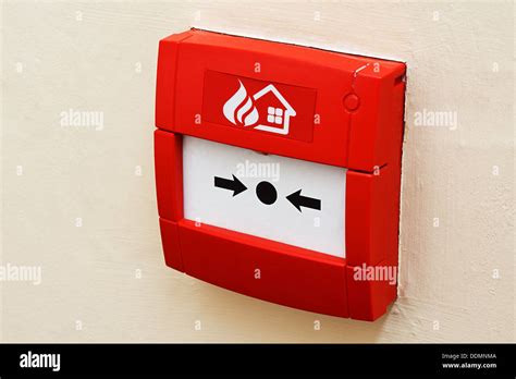 wall mounted Red fire alarm button used to activate warning systems ...