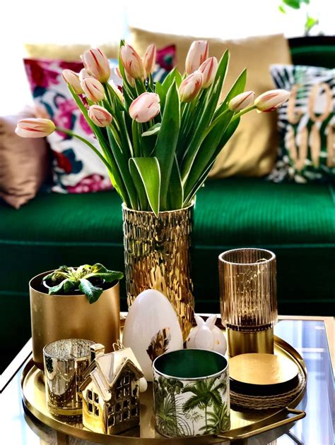 Easter decor in the living room in gold green and white with tulips; coffee table, Easter eggs ...