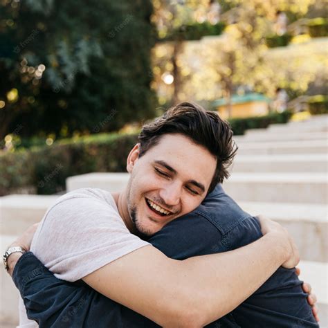 Premium Photo | Joyful father and son hugging