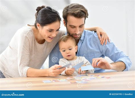 Portrait of Young Family Playing Cards Stock Image - Image of adults, love: 62234195