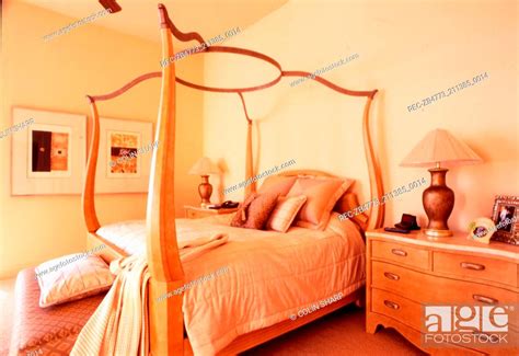 Contemporary four poster bed in yellow bedroom, Stock Photo, Picture And Rights Managed Image ...