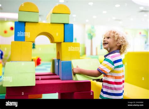 Child playing with colorful construction toy blocks. Educational toys for young kids ...