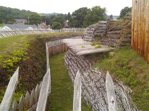 an old wooden fence is in the grass