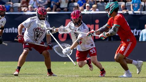 the men are playing a game of lacrosse in front of an audience at a ...