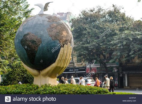 HANOI, Vietnam — An art sculpture of a globe with hands and a dove on ...