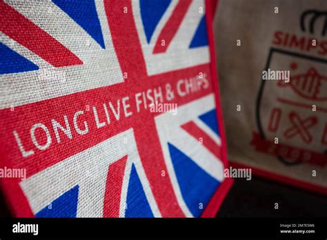 Simpsons Fish & Chip shop in Cheltenham UK. a bag in the shop with a union jack flag advertsing ...