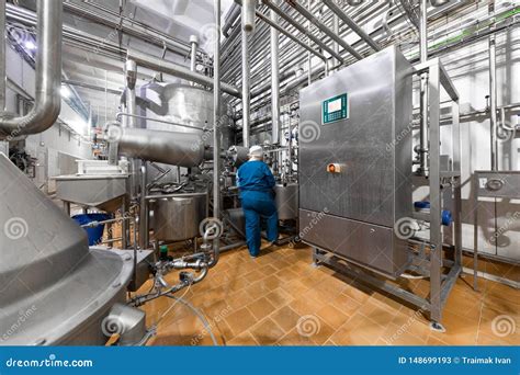 Worker in a Blue Robe and a Cap Inspect the Production Department of Dairy Factory Stock Image ...