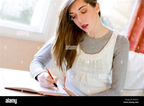 Girl writing in diary Stock Photo - Alamy