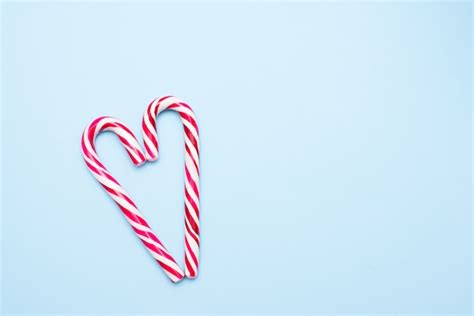 Premium Photo | Two candy canes in heart shape